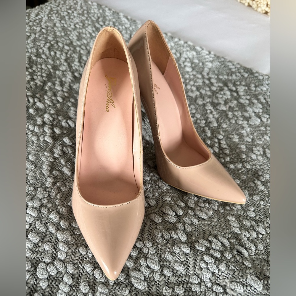 Nude patent leather pumps. Never been worn. Very cute and sassy!